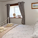 double bed with guest towels at Beudy carrog
