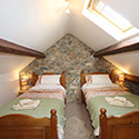 two double beds in gabled room at Beudy carrog